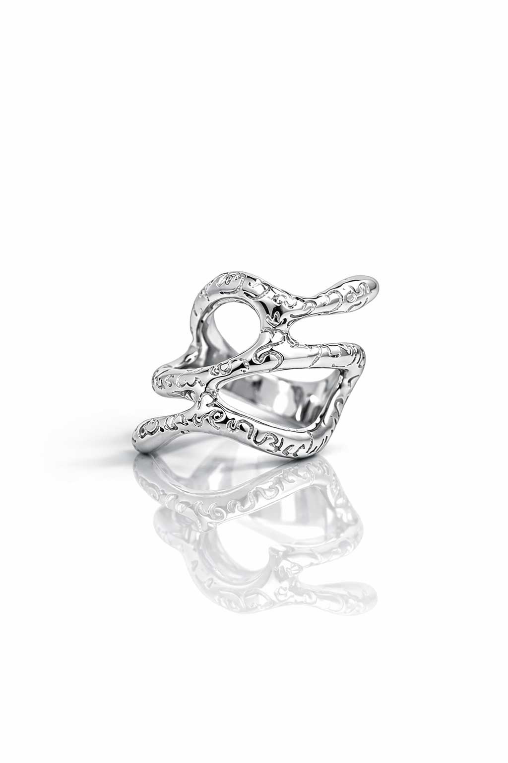 Silver ring with intricate design on a white background