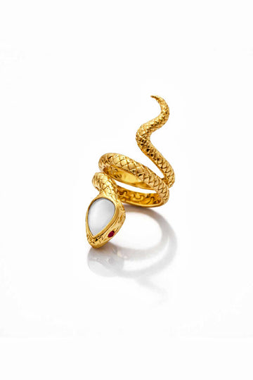 Gold snake-shaped ring with a white stone on a white background