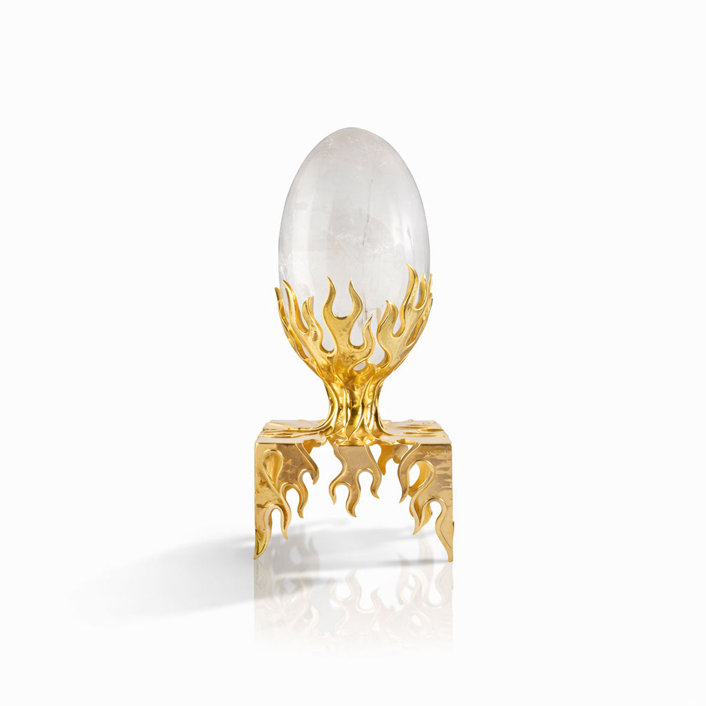Decorative egg with gold flame design on a white background