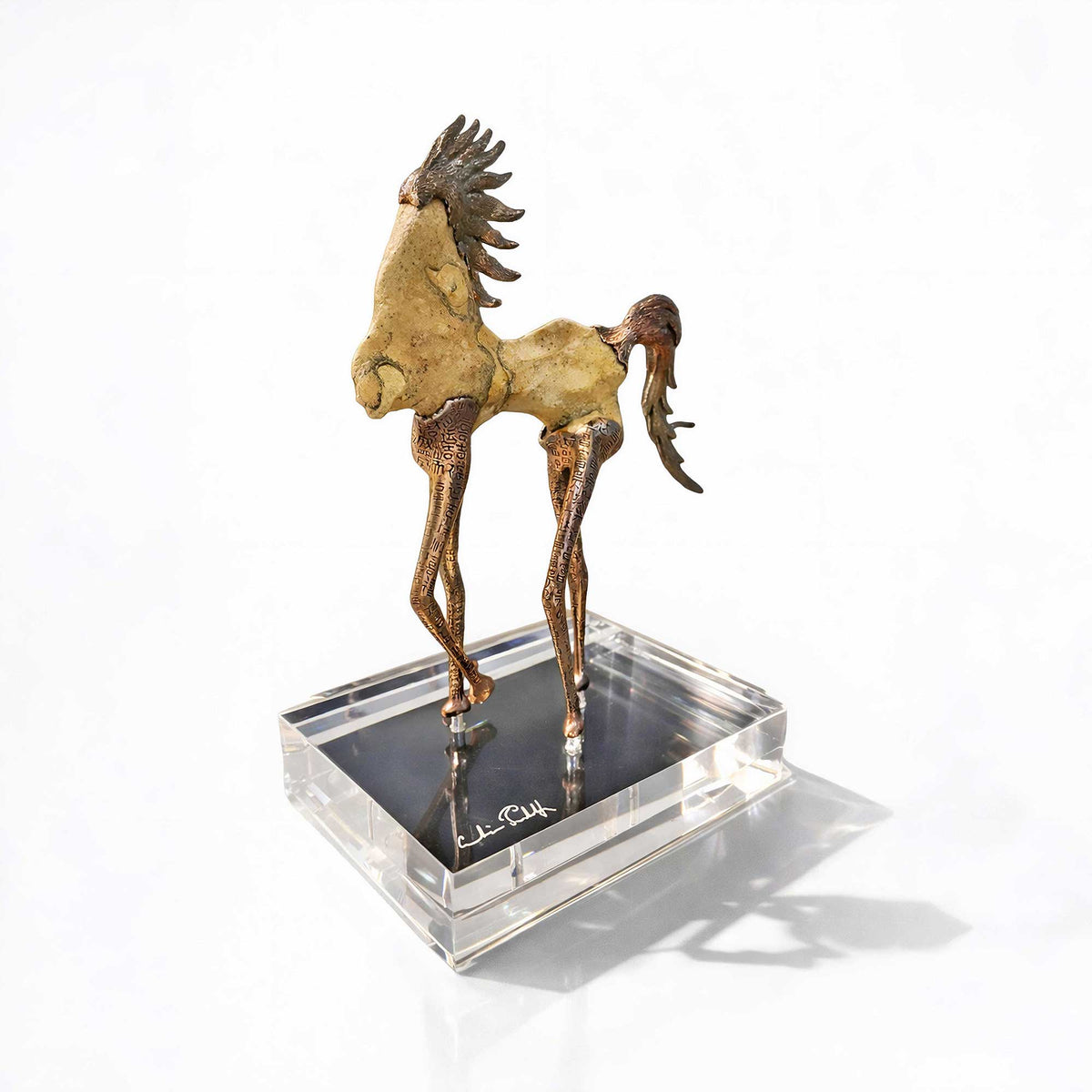 Bronze sculpture of a horse on a clear base with a white background