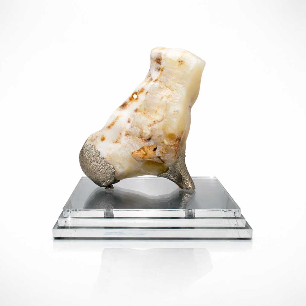 Mineral specimen on a clear acrylic stand against a white background