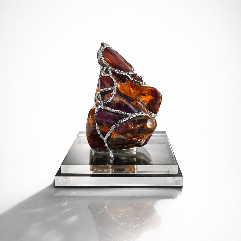 Decorative piece with amber and silver design on a white background