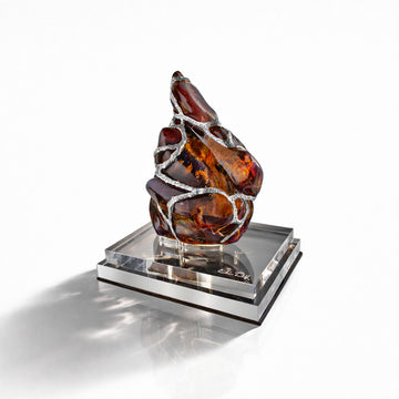 Decorative piece with amber and silver design on a white background