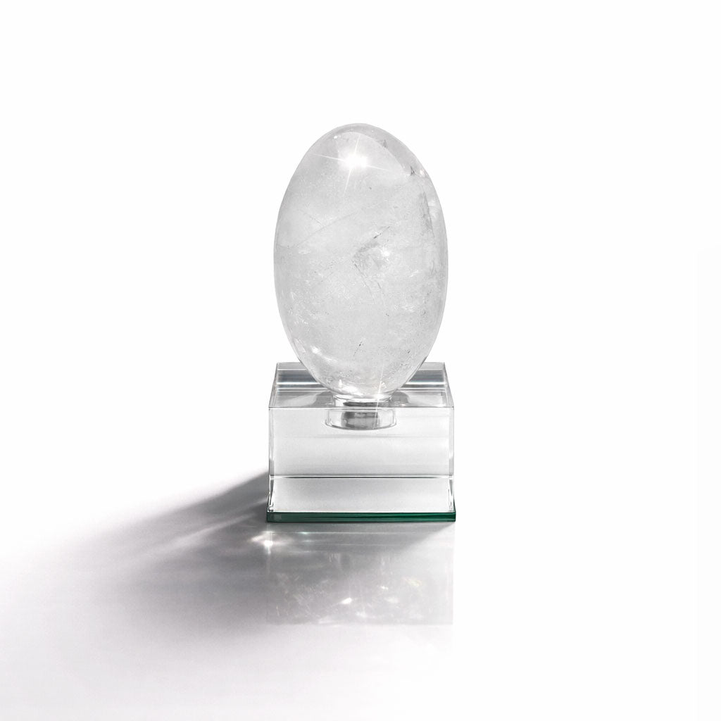 Crystal egg on a clear base against a white background
